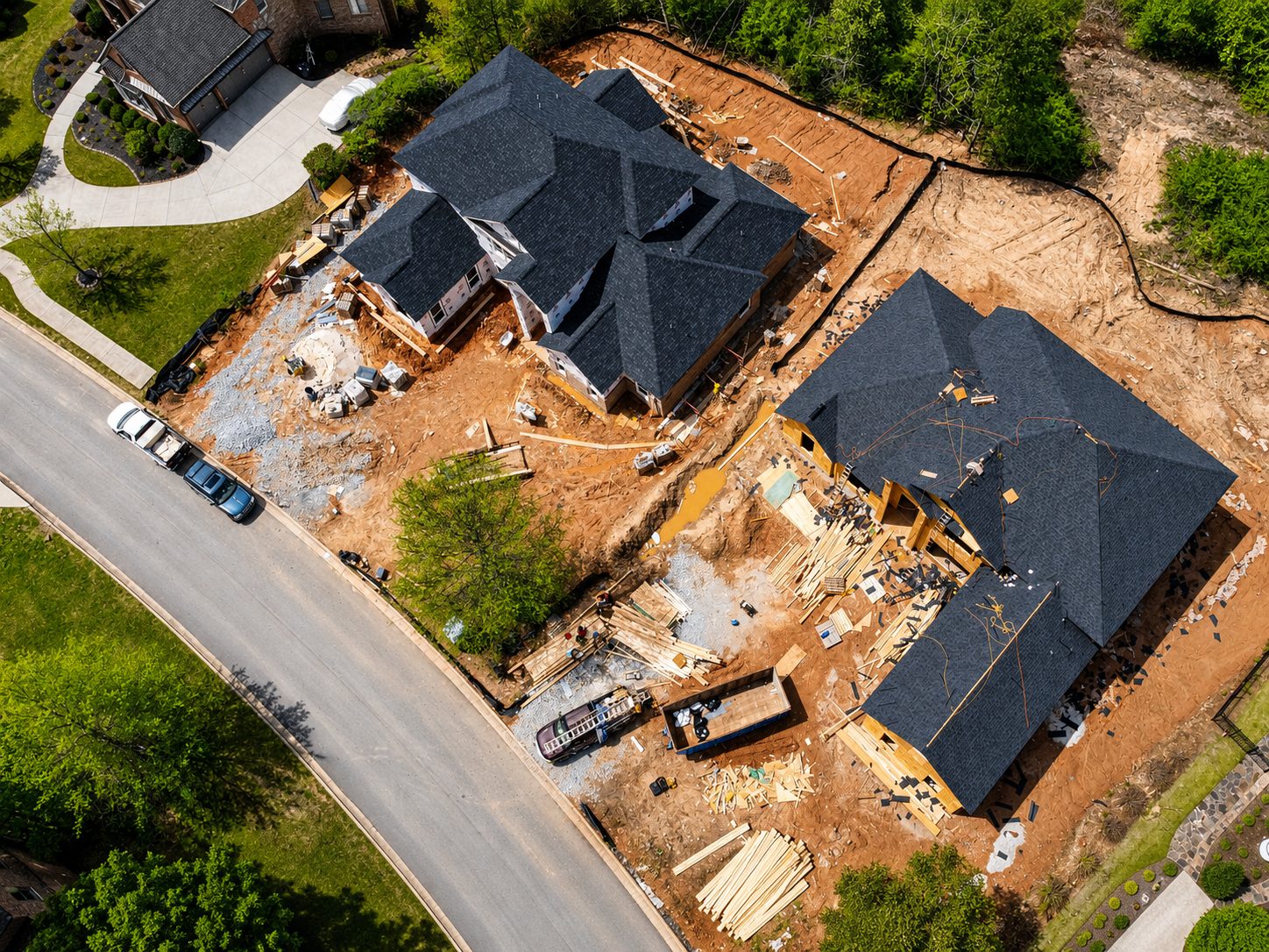 Aerial site view — homes under construction along the street