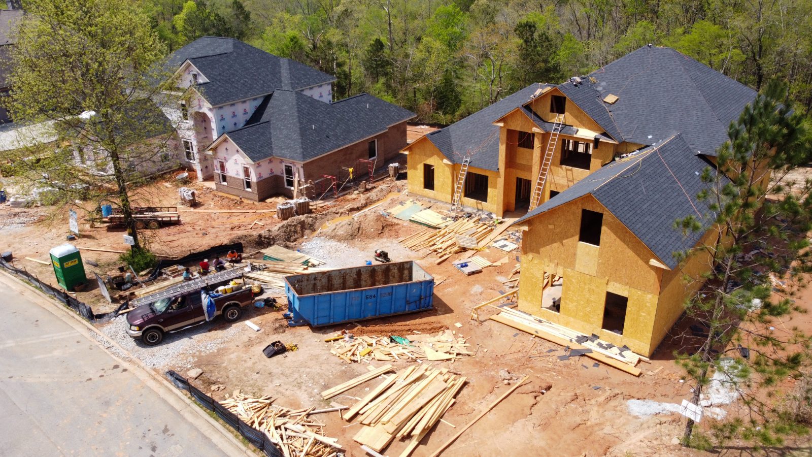 Aerial view of homes under construction — framing and rooflines in progress